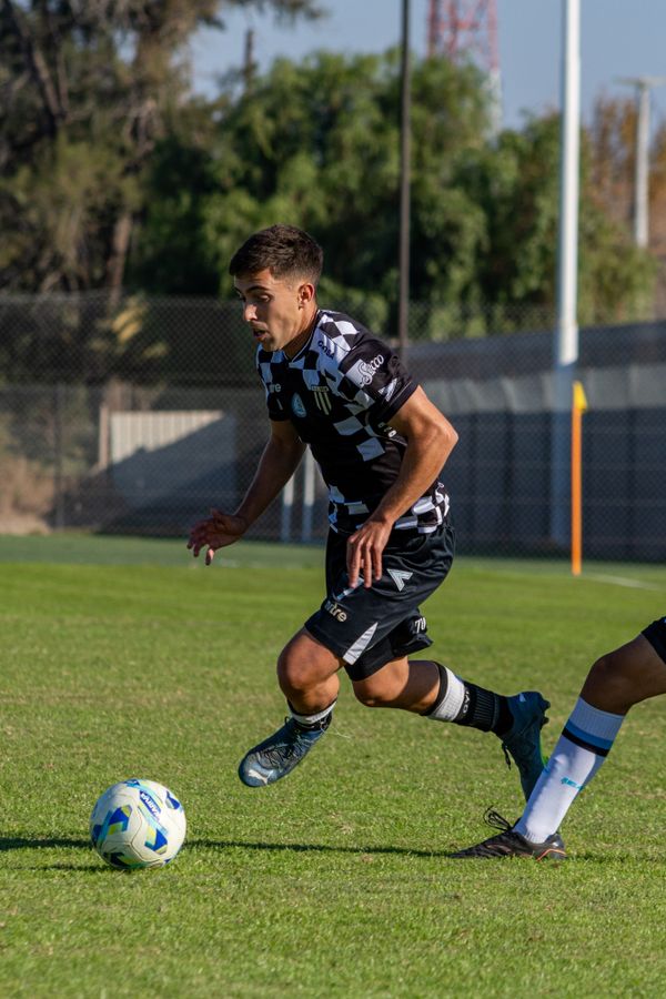 Professional footballer in action under stadium lights