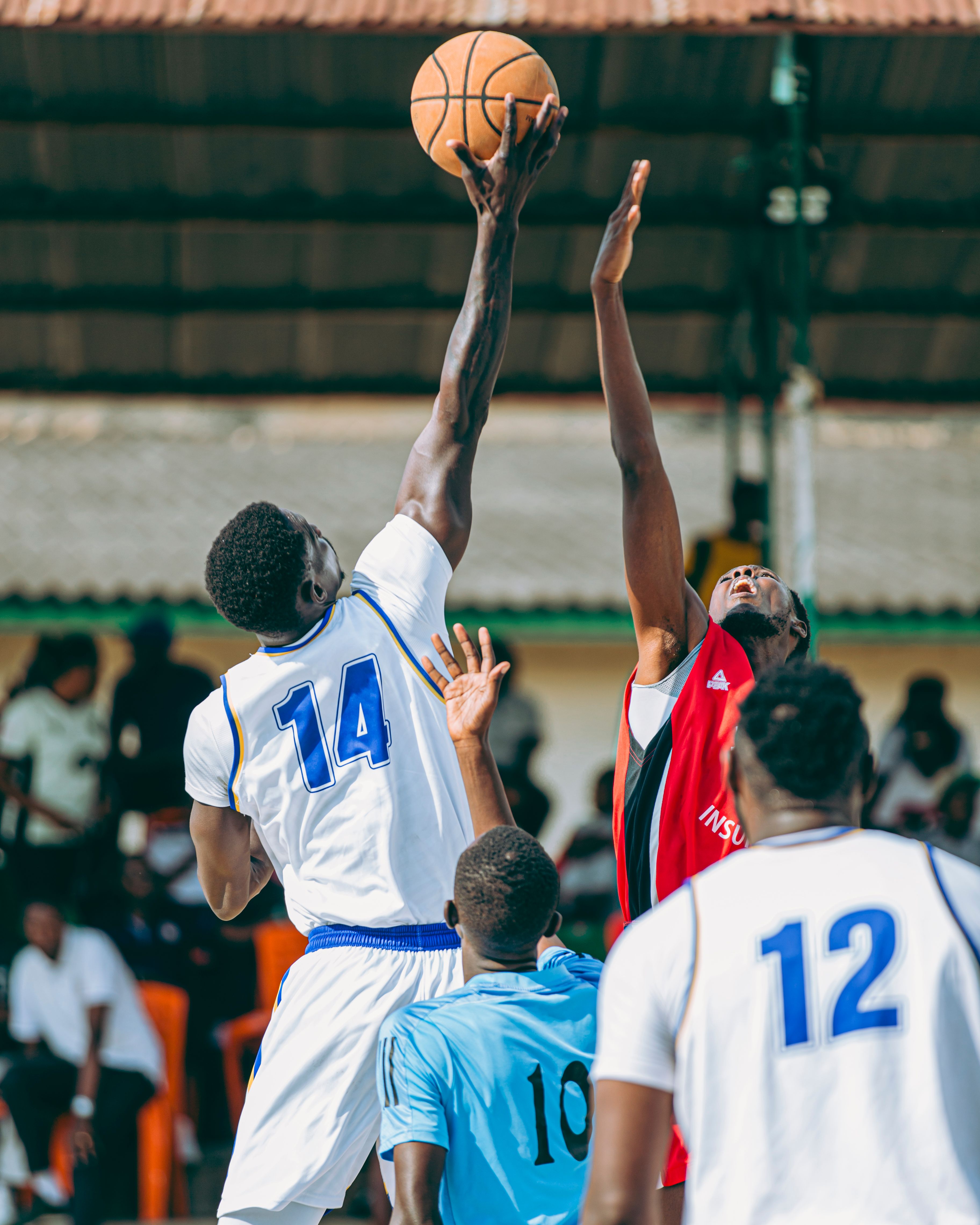 Basketball athlete dribbling under arena spotlight